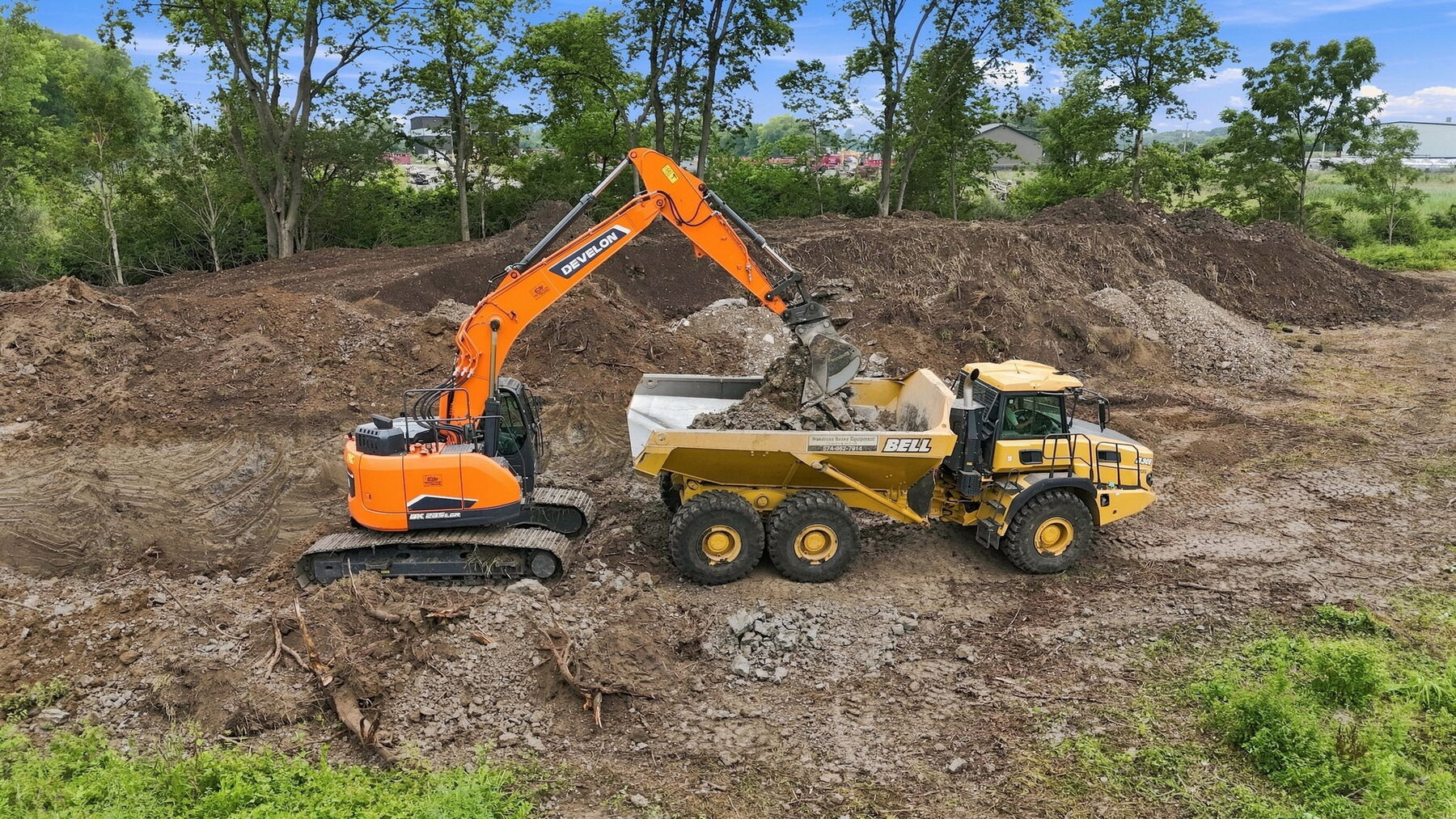 Excavator loading demolition or excavation material